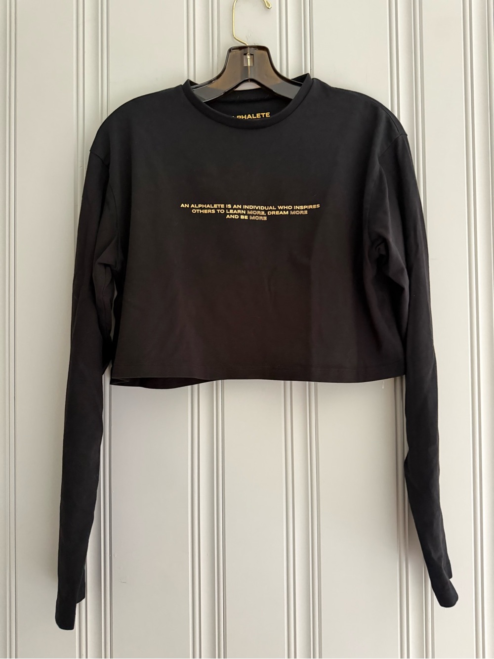 Alphalete Black Cropped Long Sleeve Top with Gold Chest Text